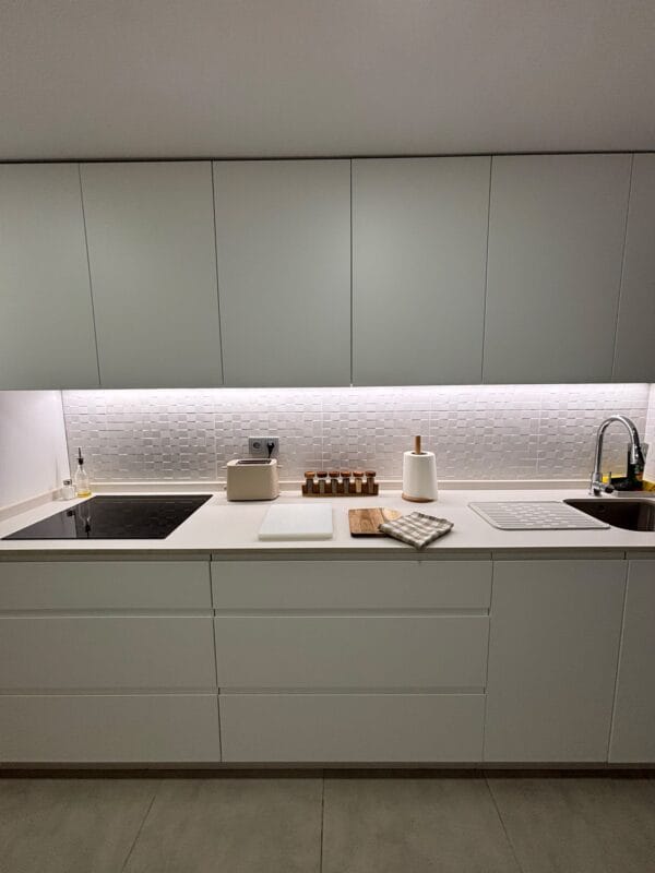 cocina blanca con luz integrada en la encimera
